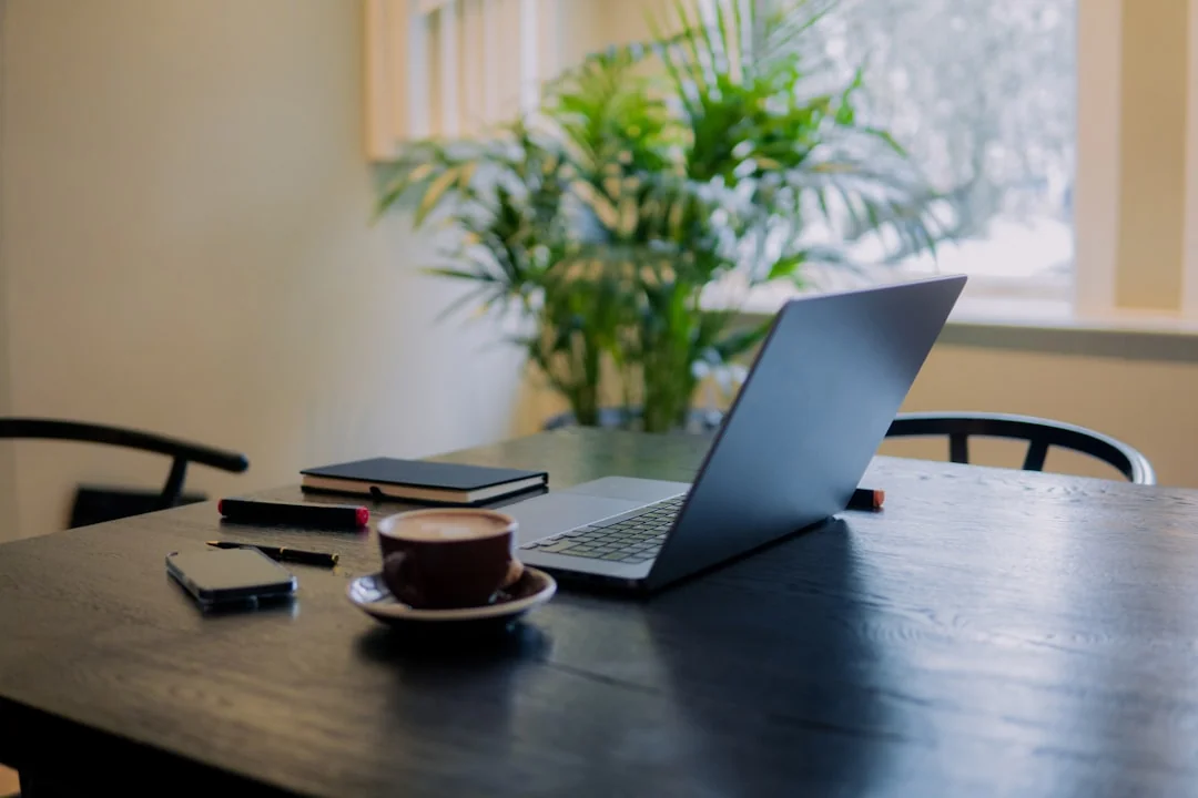 A clean and modern desk setup with a lightbox displaying #TREND and a computer monitor showing a social wall solution.