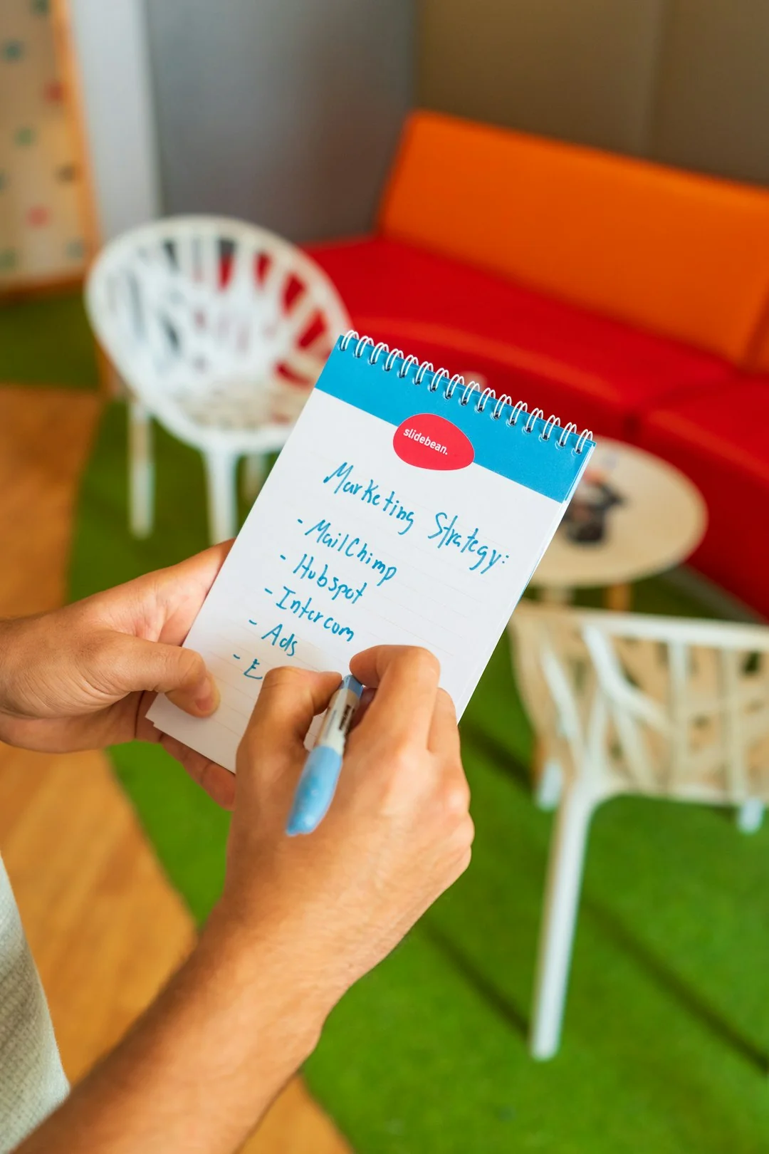A close-in view of a social media marketing document resting on a desk beside a pen and notebook.